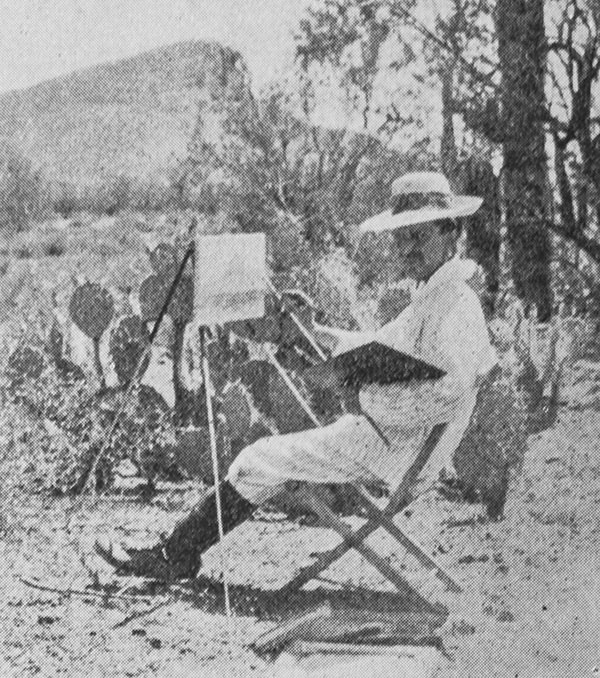 Audley Dean Nicols seated and painting in Arizona dessert